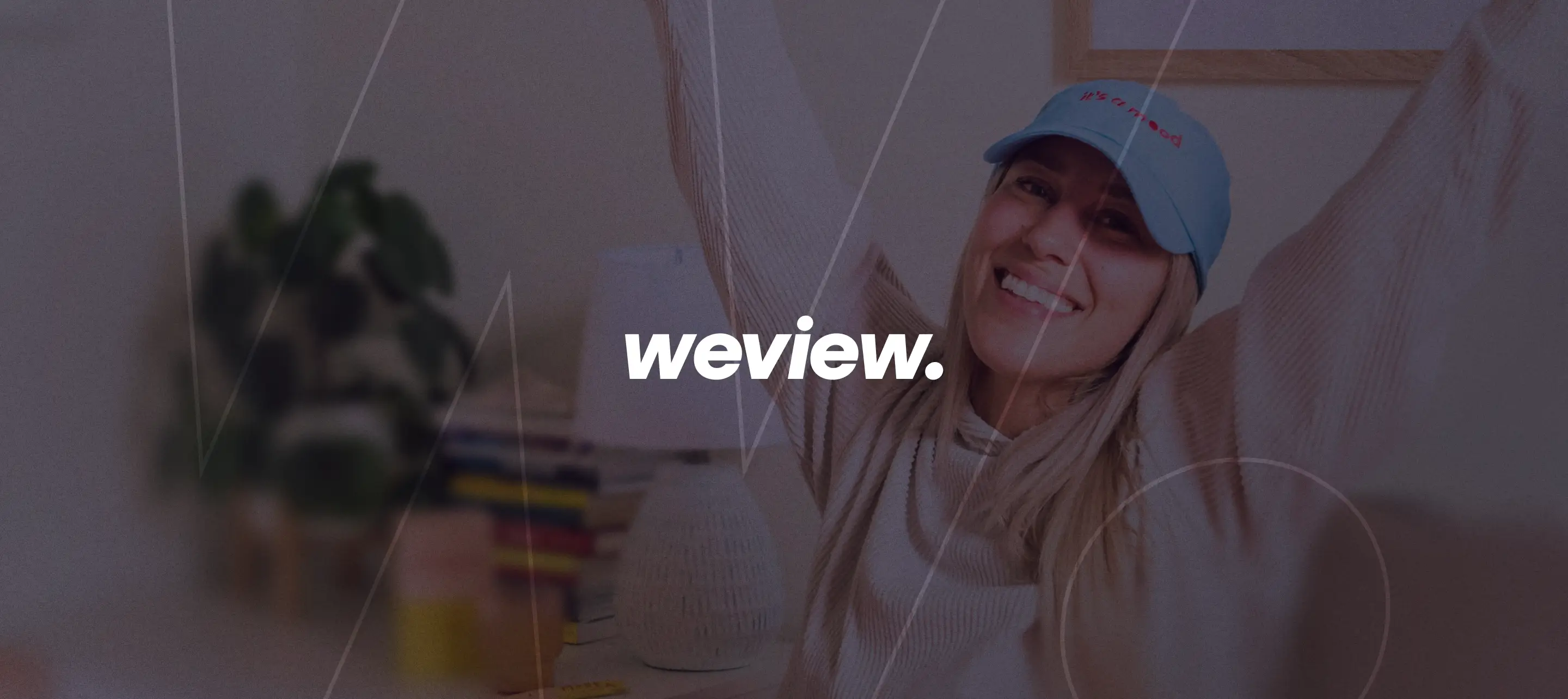 The WeView wordmark over a photo of a person at home with arms raised