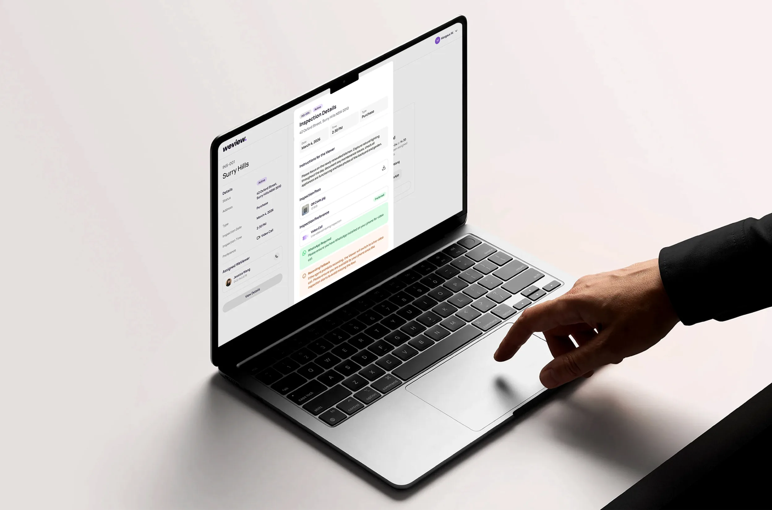 A laptop showing a WeView inspection report for a Brisbane property, with the WeViewer's notes and photos