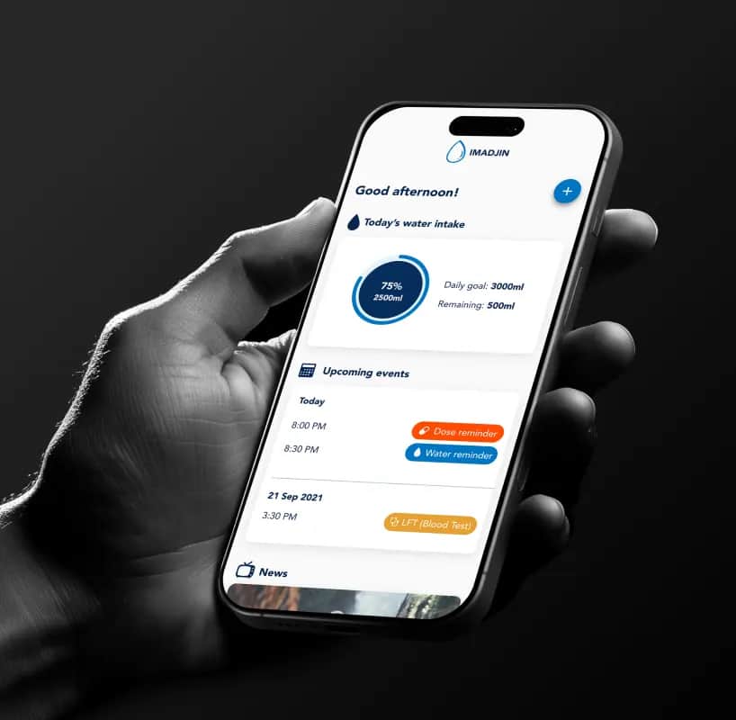 A hand holding a phone showing the IMADJIN hydration app